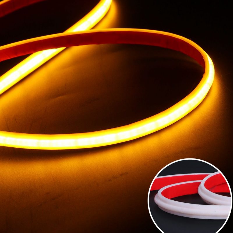 Warm amber LED strip light curled into loops on a dark surface; inset shows red and white variants.
