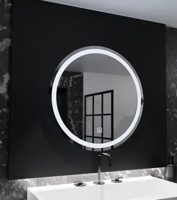 Round backlit mirror above a white countertop sink with a tall black faucet in a dark marble bathroom.