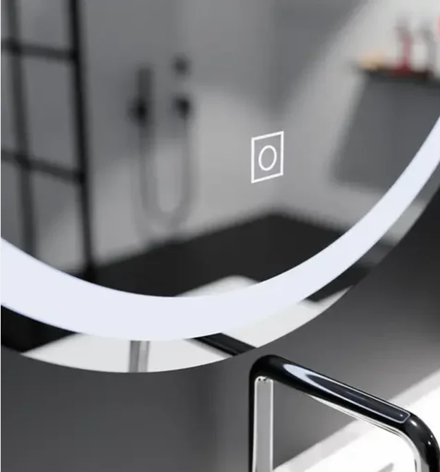 Close-up of a glass panel with a small square icon containing a circle, suggesting a touch button or power indicator.