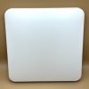 White rounded-square panel/device on a beige surface.