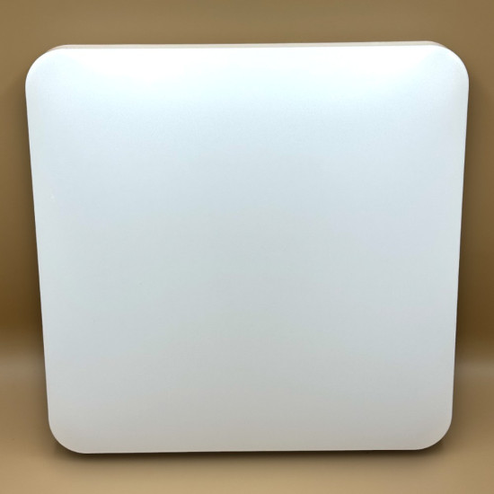 White rounded-square panel/device on a beige surface.