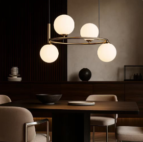 Modern dining room with a round chandelier of four globe lights over a wooden table.