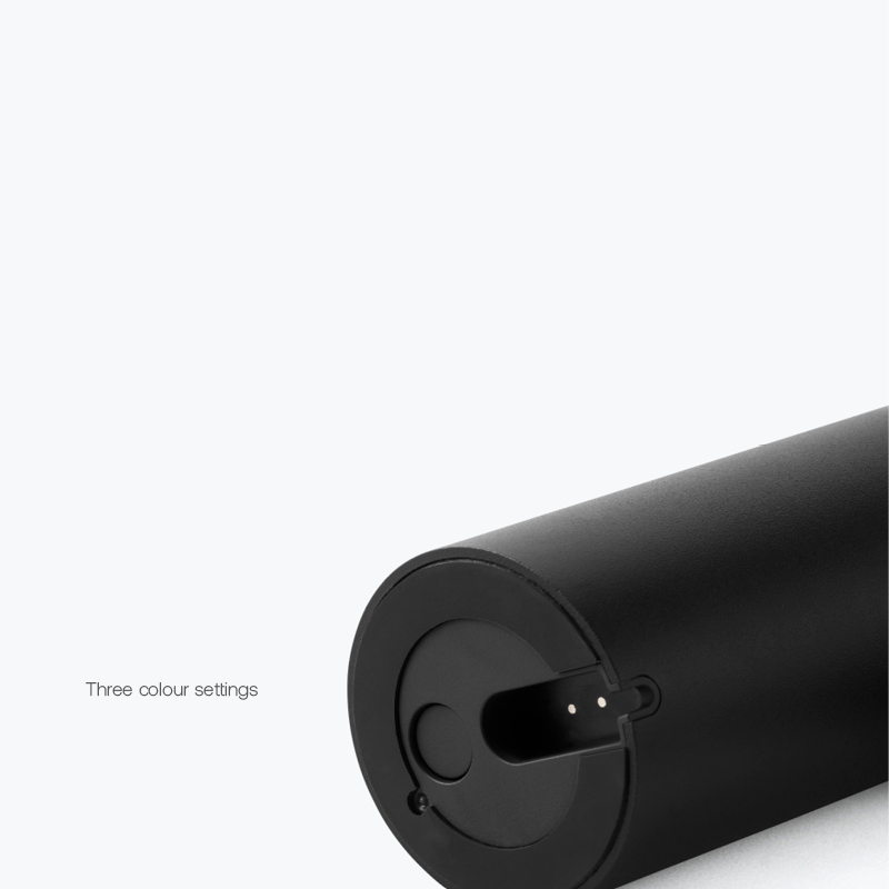 Black cylindrical device shown at an angle with its end facing the camera; caption reads 'Three colour settings' indicating adjustable colors.