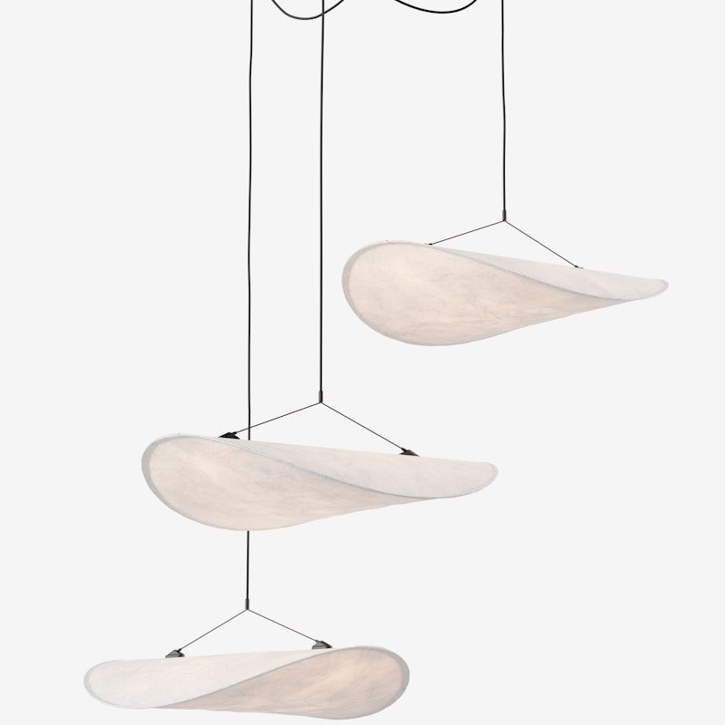 Modern hanging chandelier with three curved, wing-shaped fabric panels suspended by black cords from a round ceiling mount.