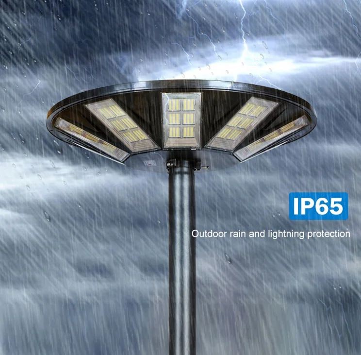 Circular outdoor LED street lamp on a pole in heavy rain, with IP65 rain protection emphasized in the image.