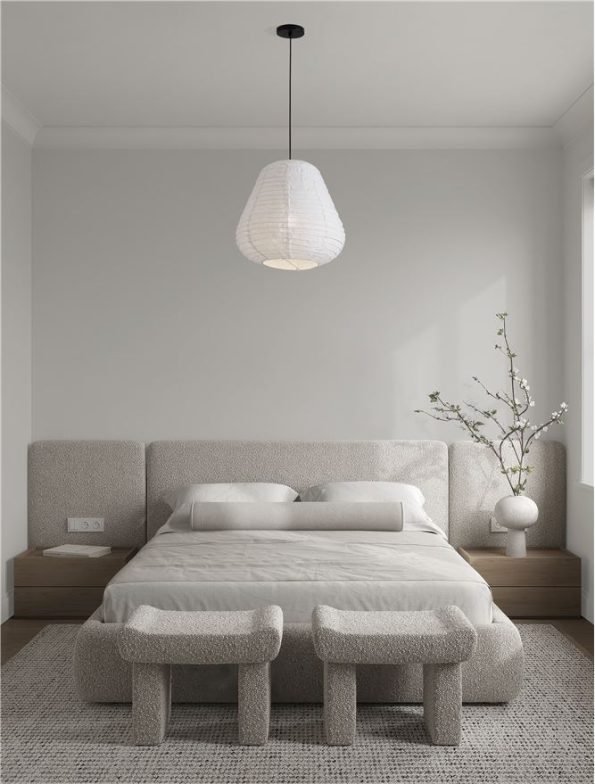 Minimalist beige bedroom with a padded headboard bed, two nightstands, a woven pendant light, and two upholstered stools at the foot of the bed.