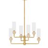 Gold metal chandelier with multiple white cylindrical shades arranged around a central frame, hanging from a ceiling mount.