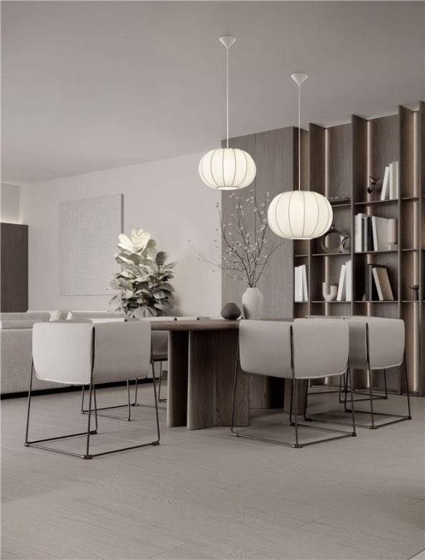 Modern dining room with a wooden table, white chairs, and two round pendant lights in a neutral-toned space