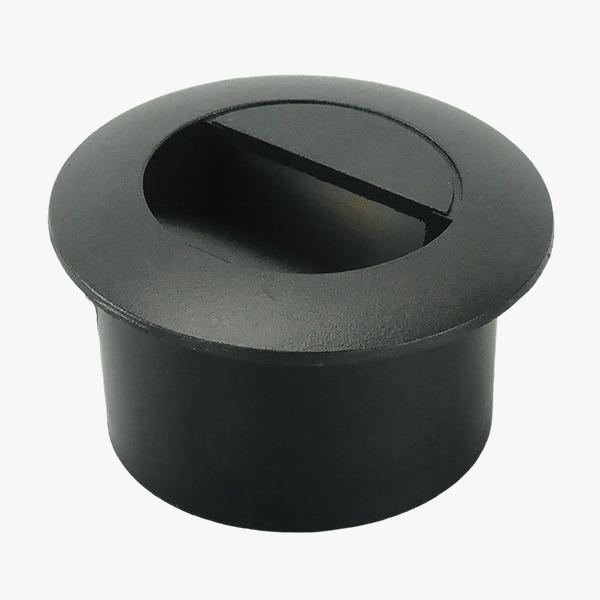 Black cylindrical plastic plug with a recessed top and a horizontal slot, likely a snap-in furniture or hardware cover used to conceal an opening.
