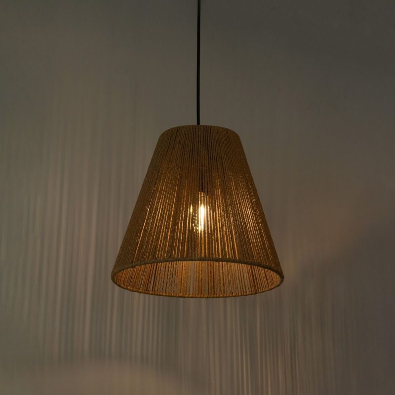 Brown woven pendant lamp hanging from a black cord, emitting warm light into a dim room.
