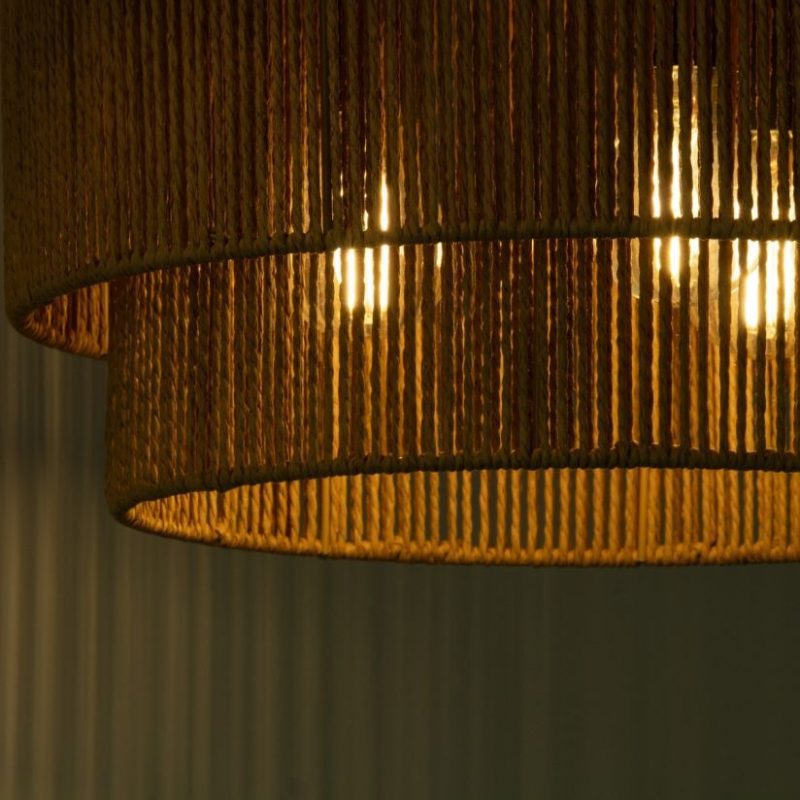 Close-up of a warm, woven rattan lampshade emitting a soft golden glow