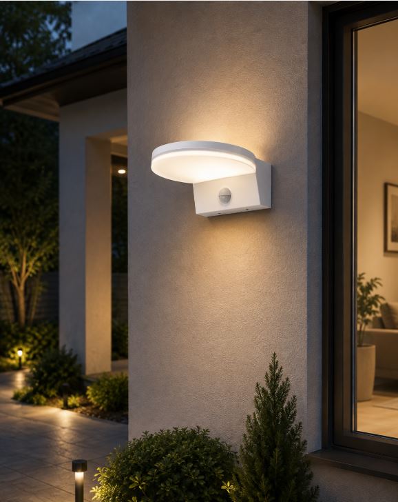 White outdoor wall light mounted on beige stucco wall, emitting warm glow at dusk near entryway.
