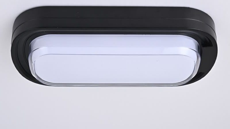 Modern rectangular ceiling LED light fixture with a black outer frame and white diffuser on a white ceiling.