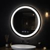 Round illuminated mirror above a white sink in a dark bathroom, with a hanging bulb and diffuser sticks on the counter.
