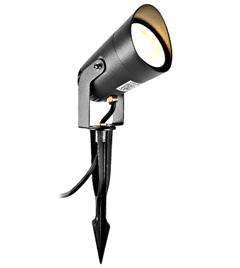 Black outdoor ground-spike spotlight with adjustable head for garden lighting, wired to power source.