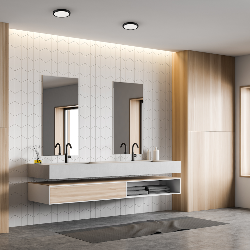 Double-sink vanity in a modern bathroom with geometric tile wall, two mirrors and wood storage cabinets.
